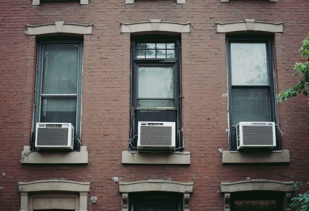 Window air conditioners on a Northeastern rowhouse.