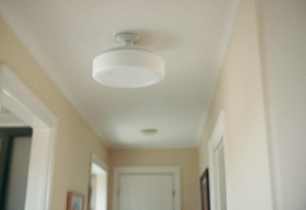 A carbon monoxide alarm in a hallway outside the bedrooms.