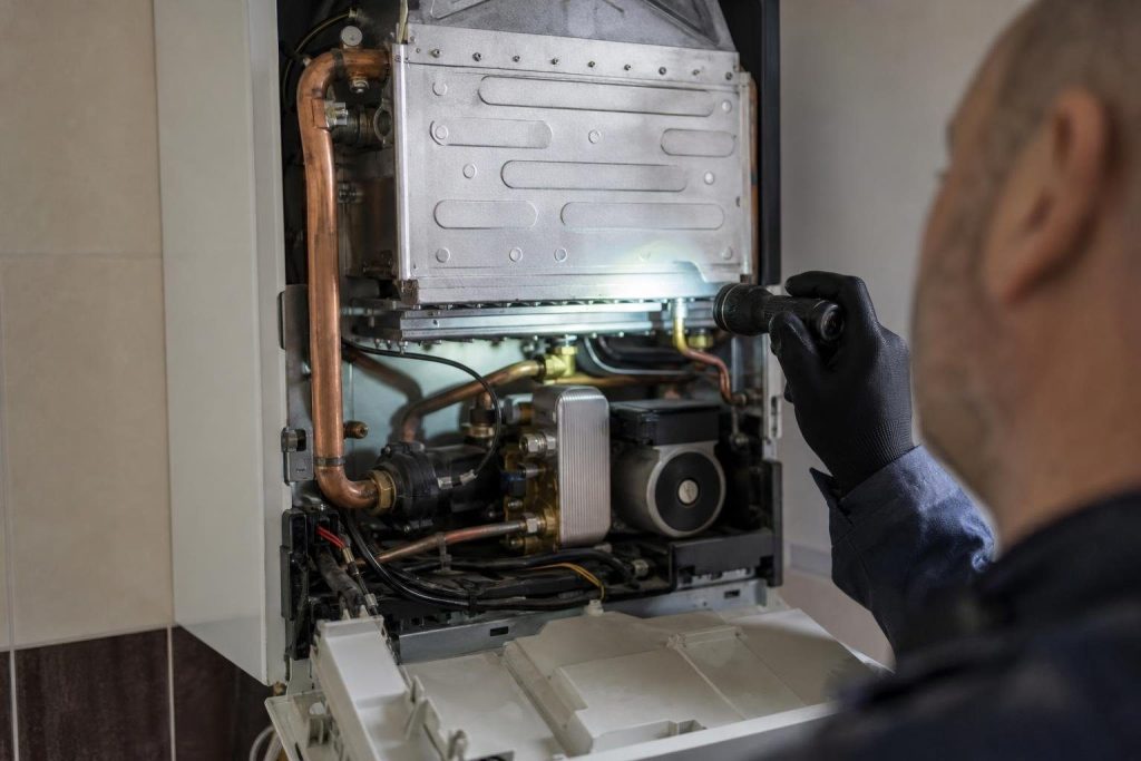 Inside a combi: one burner feeds both the heating loop and a plate heat exchanger for tap water.