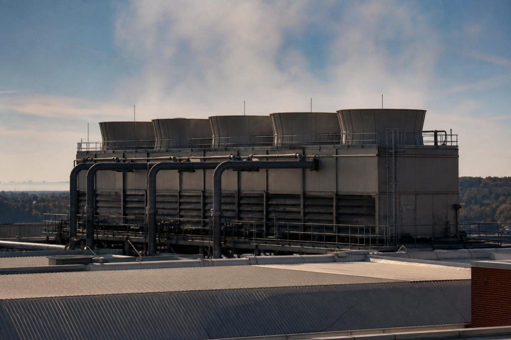 Packaged cooling tower cells on a commercial roof.