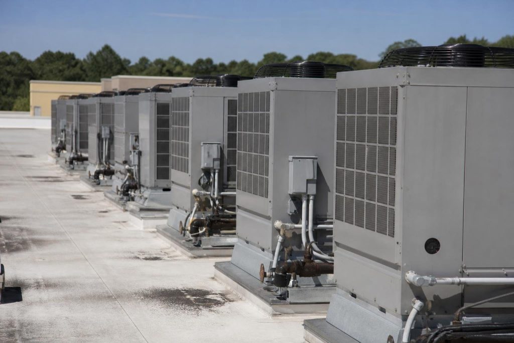 Big rooftop units serving one open space are where duct detector rules and their exceptions get tested.