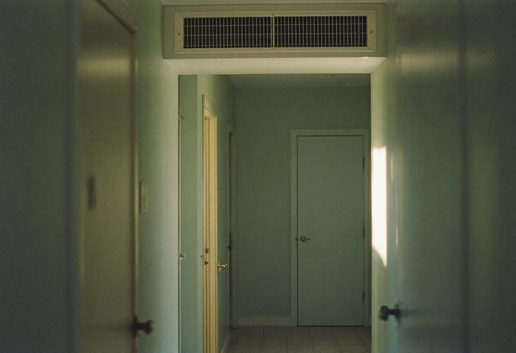 A transfer grille above a bedroom door gives return air a path when the door is shut.