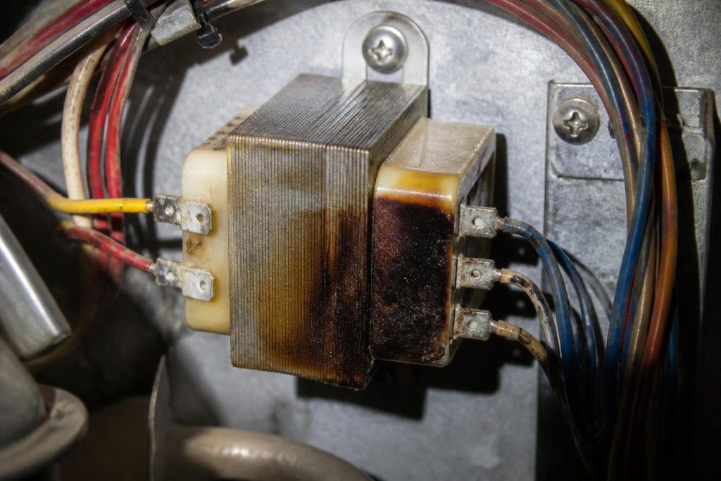 Scorching on the windings is the classic sign of a transformer that ran into a short.