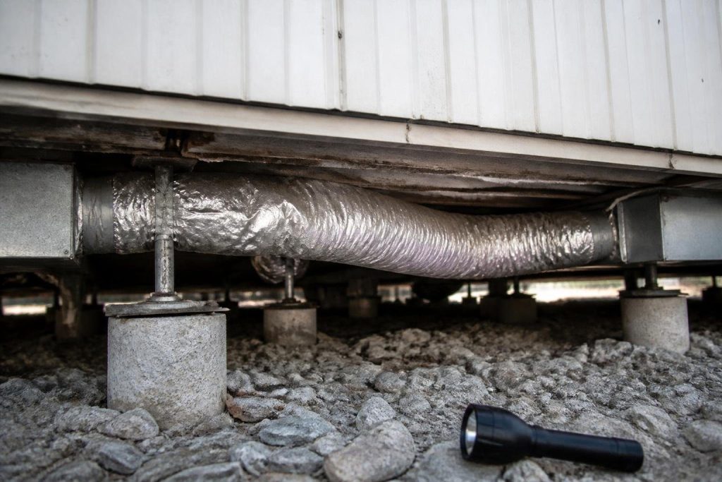 Furnace air runs through floor ducts and, in double-wides, a crossover duct under the home.
