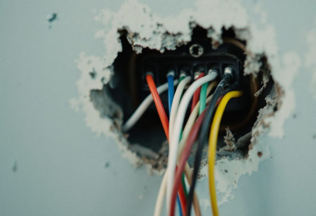 Thermostat wires at the wall: the colors are a convention, not a standard.